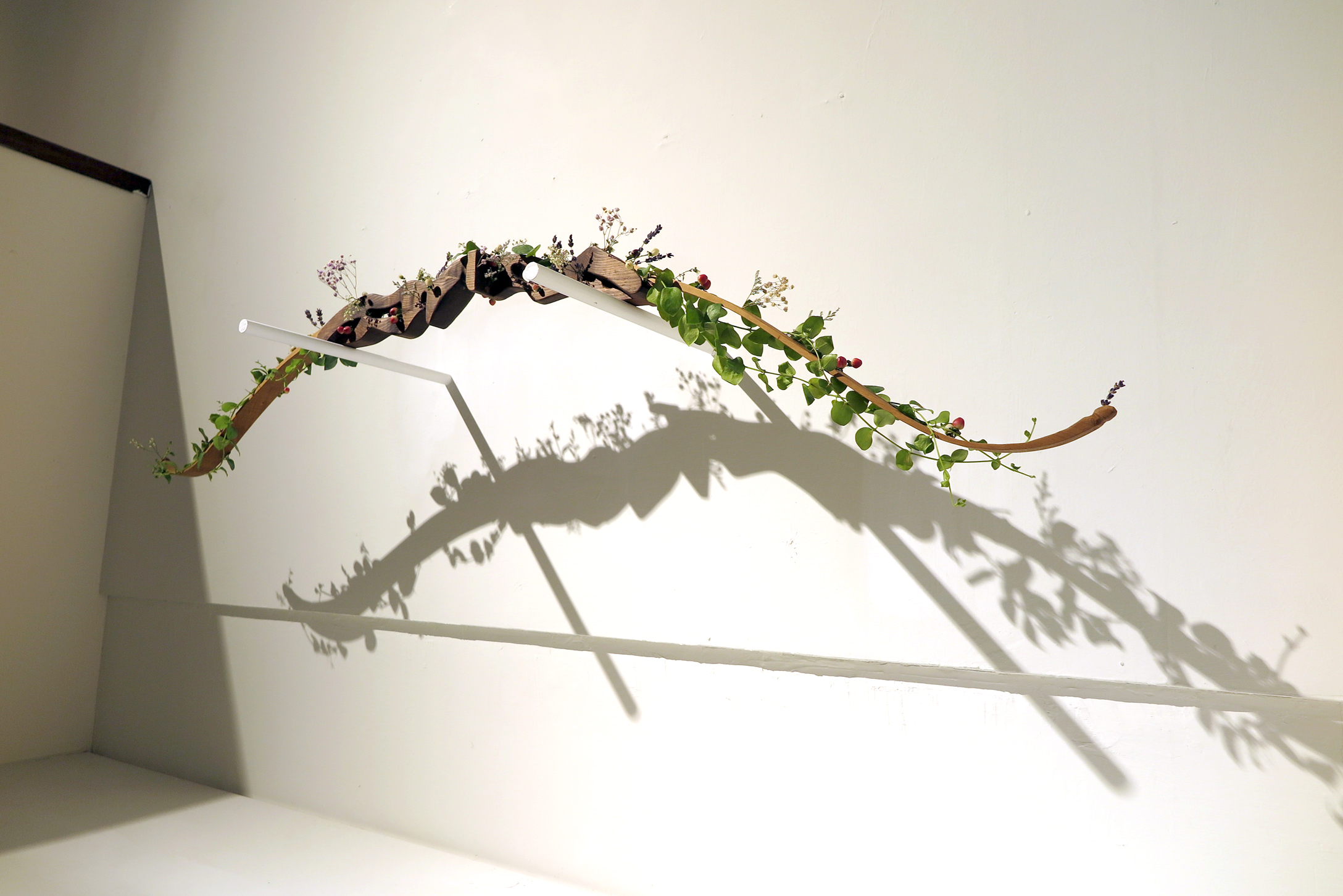 张纳祈同学的作品「放下」对战争的正当性提出质问，并透过亲手雕刻的弓箭与装置上的植物来表达「爱」才是能让纷争得以消弭的最终答案。