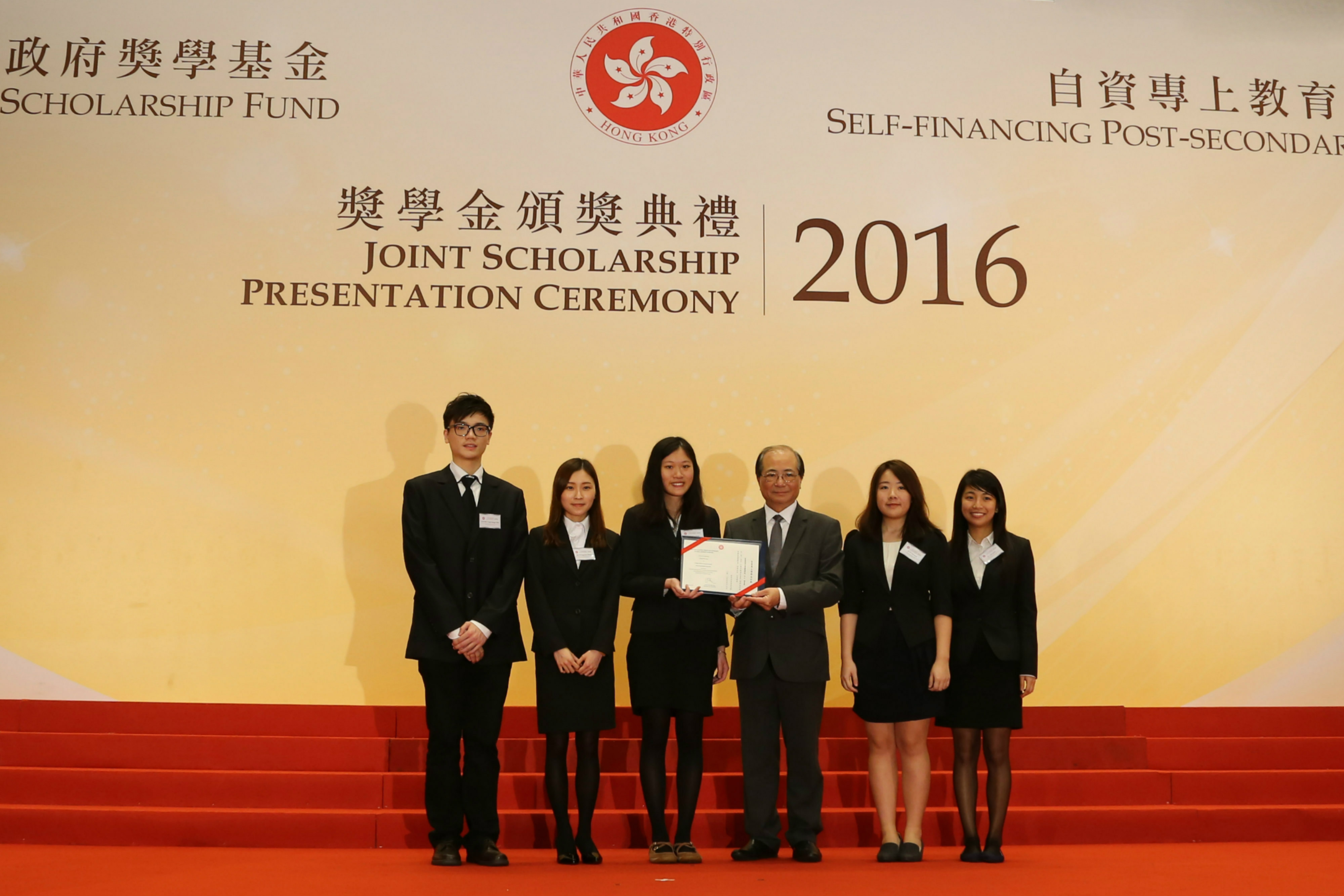 Mr. Eddie Ng Hak Kim, Secretary for Education (fourth from left), presenting a certificate to awardee representatives from CIE.
