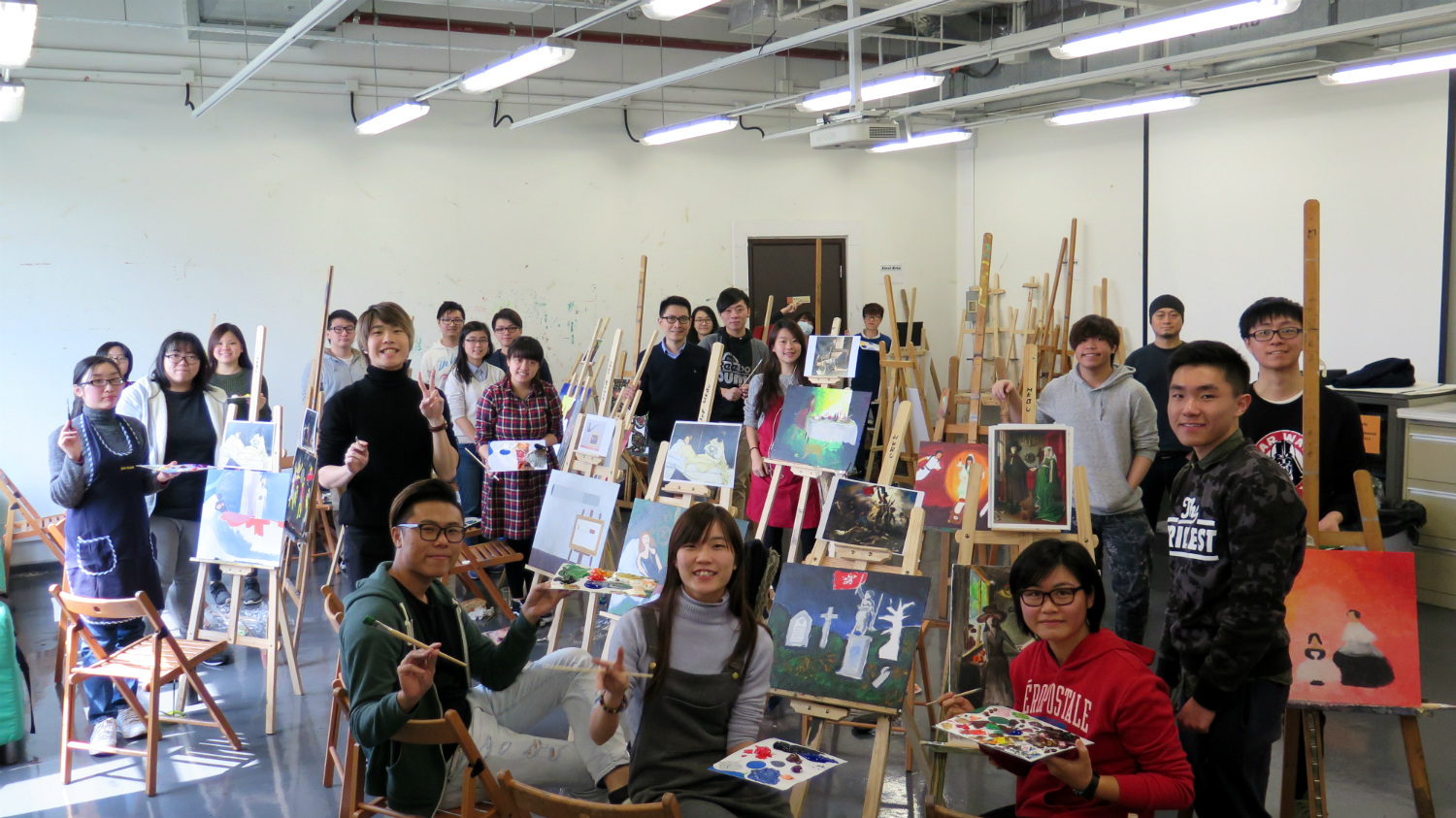 Students were painting at individual easels at the painting studio of the Academy of Visual Arts.