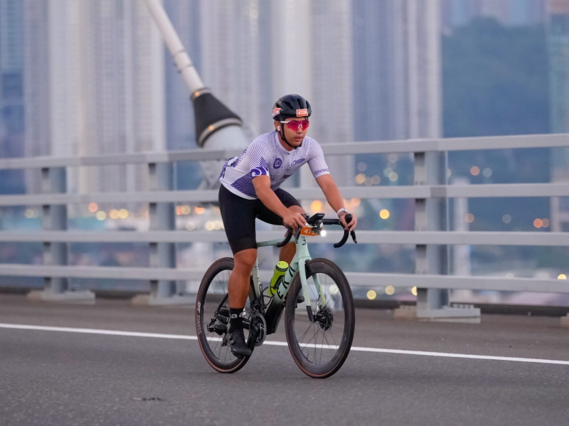 The picture shows Yim Long Ho. He and the team navigated high-speed peloton dynamics and strong headwinds, employing effective tactics and supporting each other to sprint to the finish line.